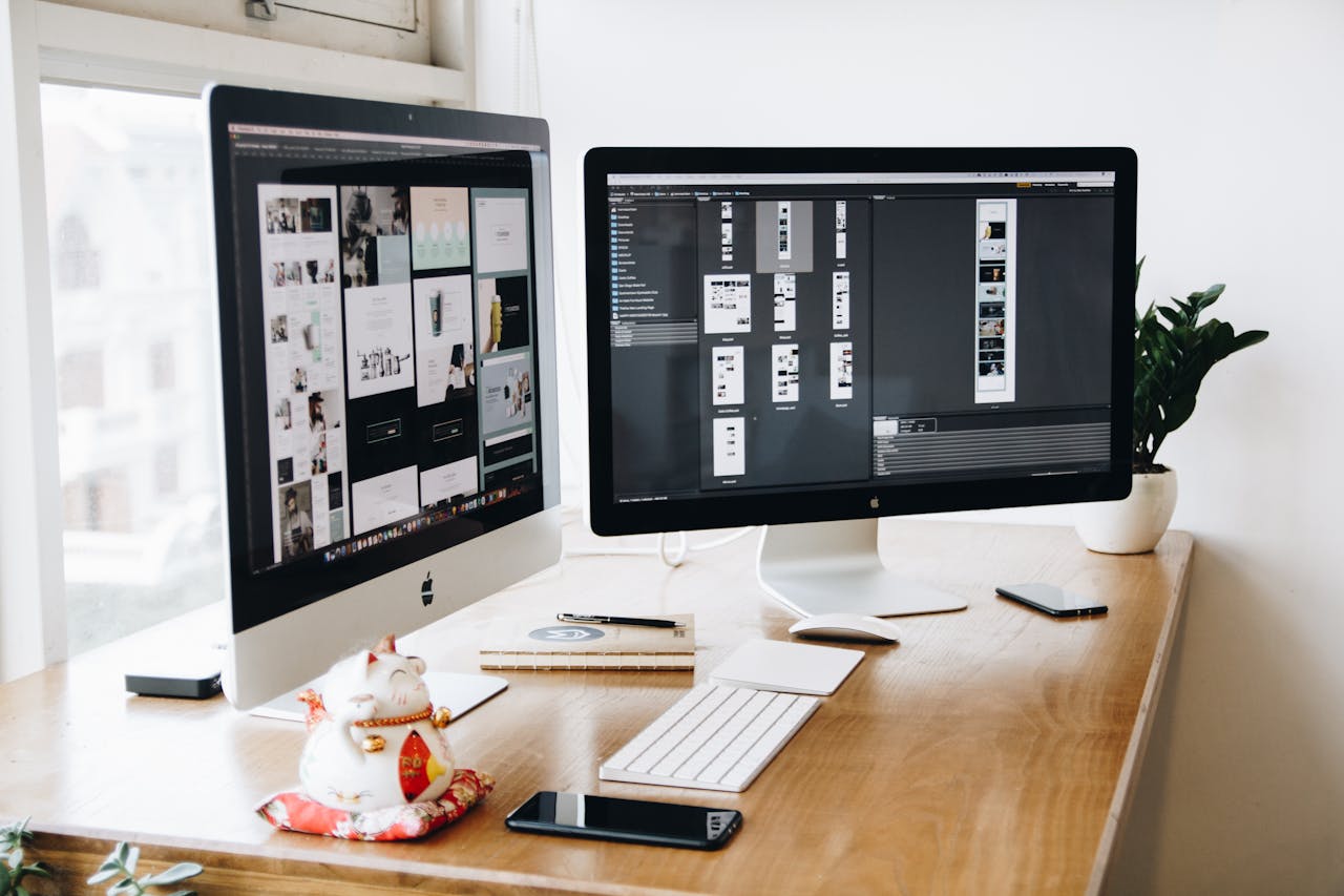 Home A well-organized design workspace with dual monitors and design software on display.